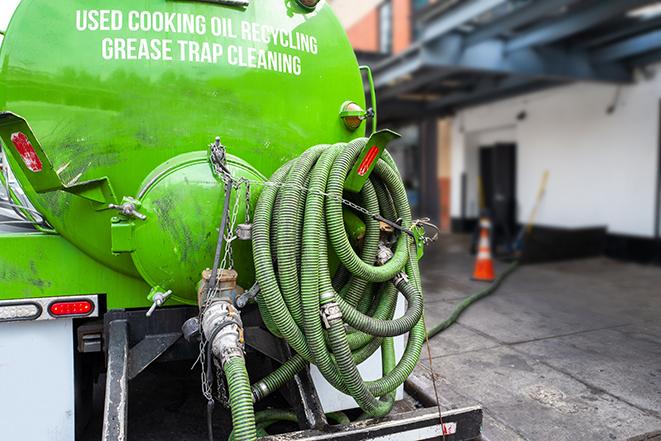 a professional technician pumping a restaurant's grease trap in Campbell Hall, NY